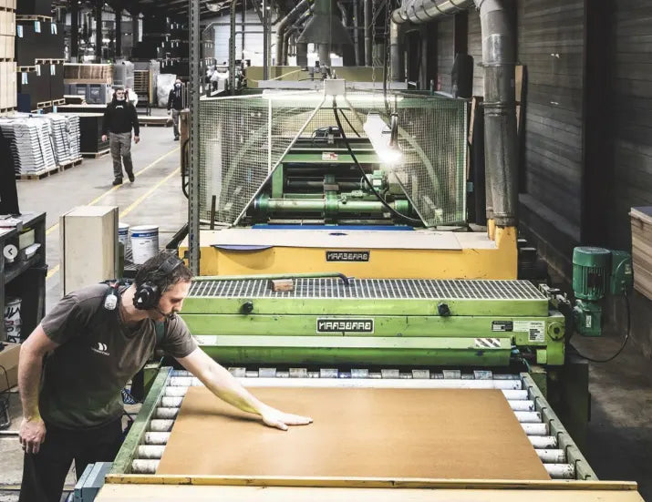 Person operating a large industrial machine in a warehouse setting