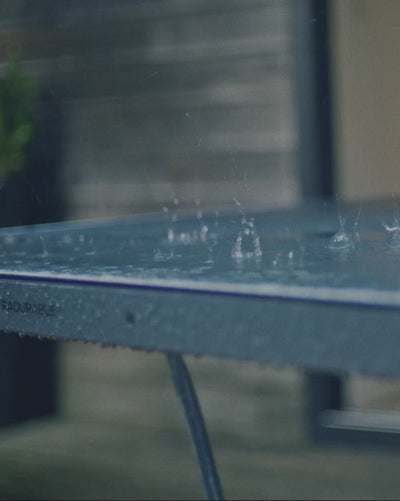 Kid playing ping pong in the rain